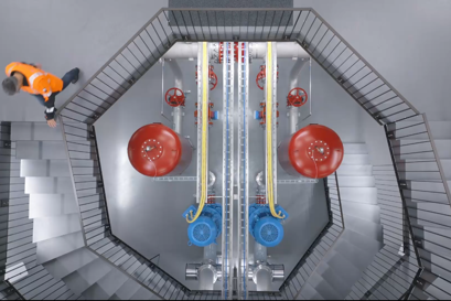 Hanspeter Sommer walking down the stairs inside Wehrliau pumping station in Bern