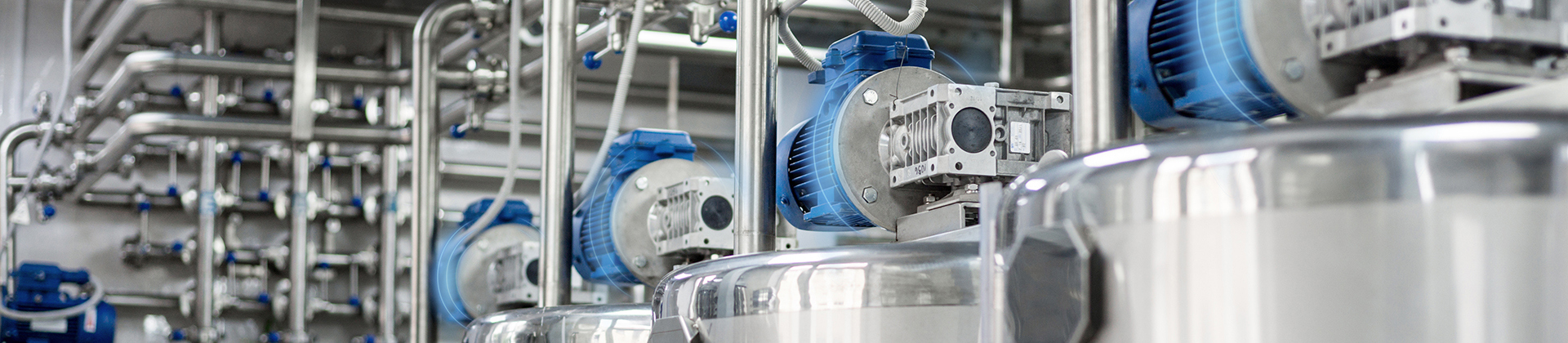 Close-up of motors with halos of blue lights, indicating condition monitoring